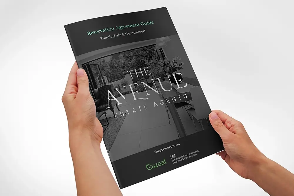 Hands holding The Avenue Reservation Agreement Guide brochure